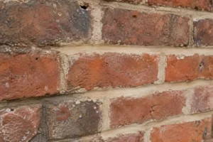 Close-up of soft antique brick repointed with light buff lime mortar